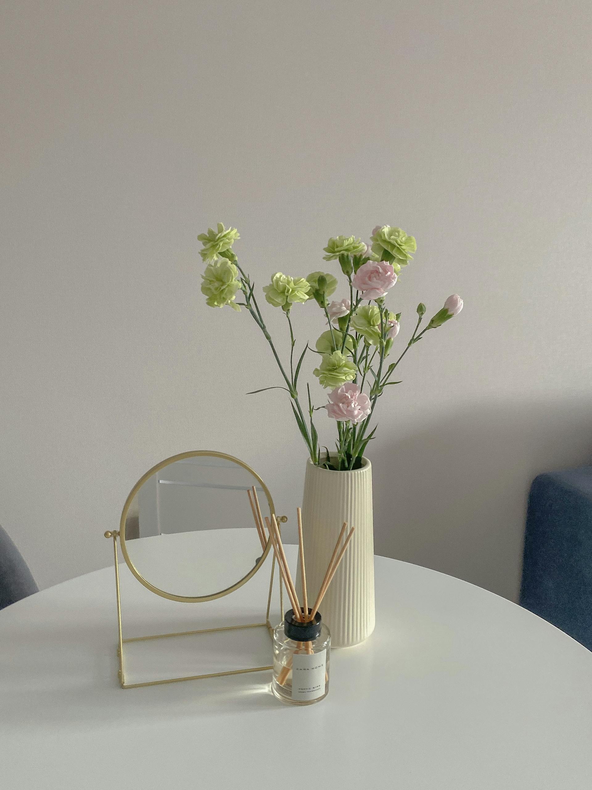 Round Mirror Near a Flower Vase